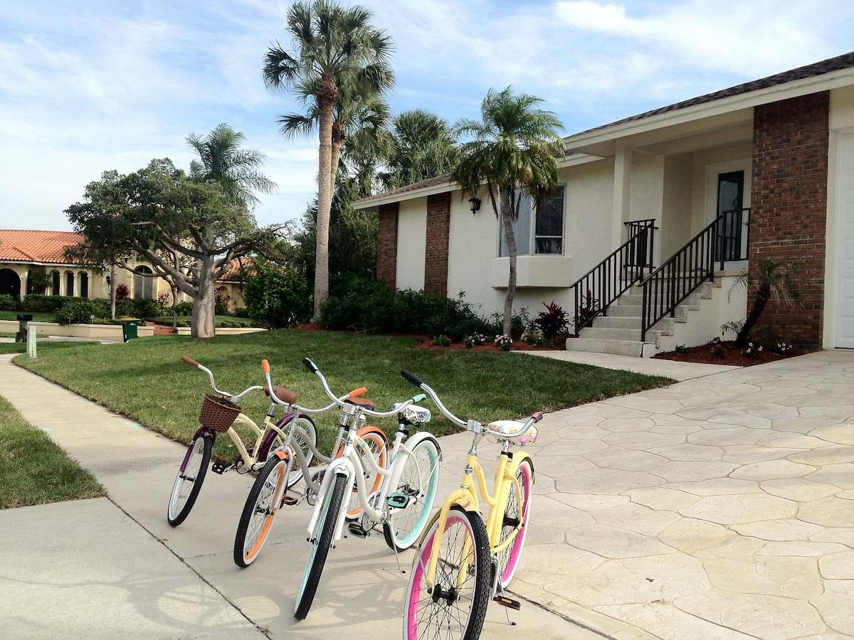 Five cruiser bikes parked on the driveway in front of the house