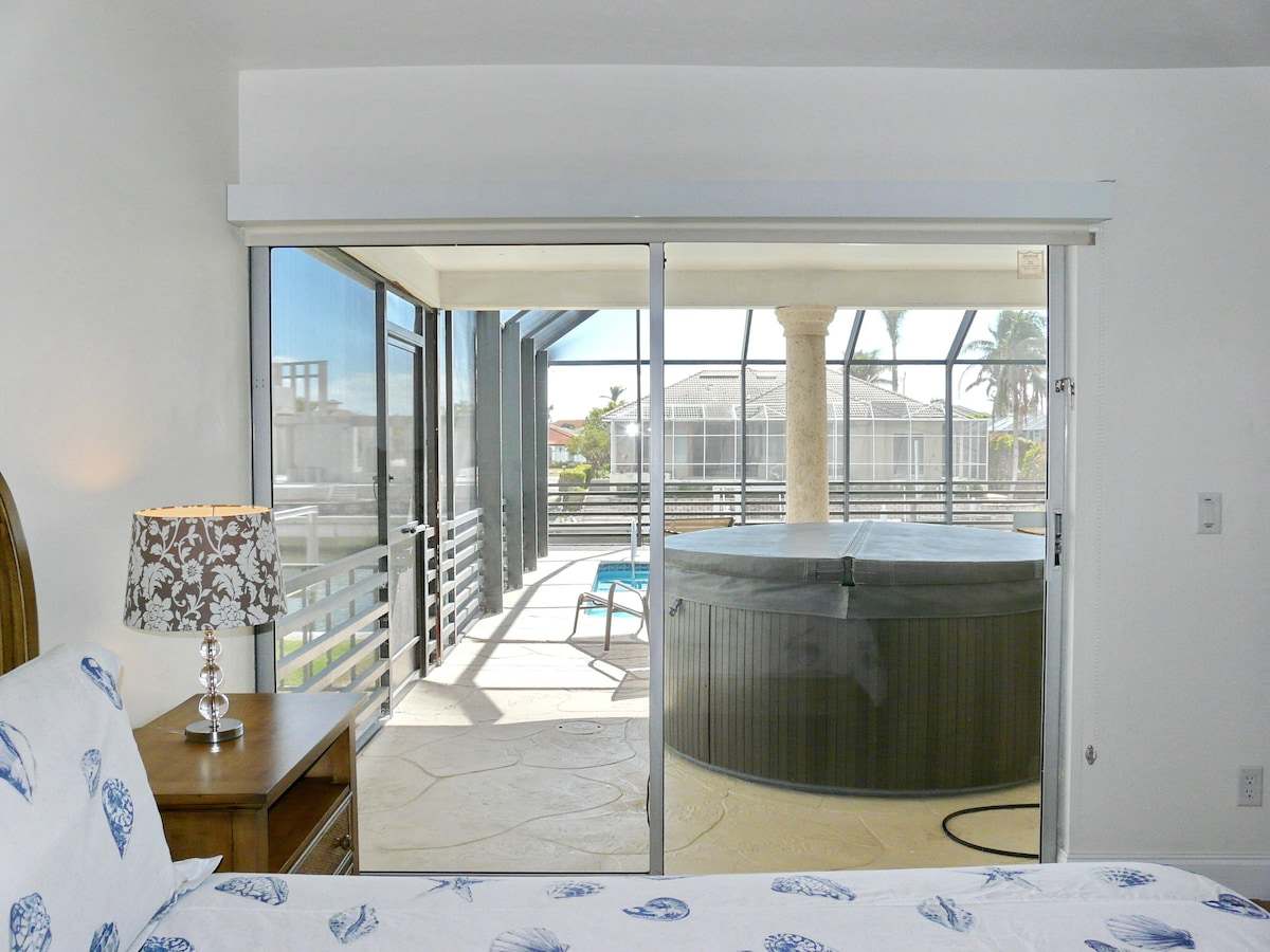 Bedroom looking out to the covered spa on the lanai