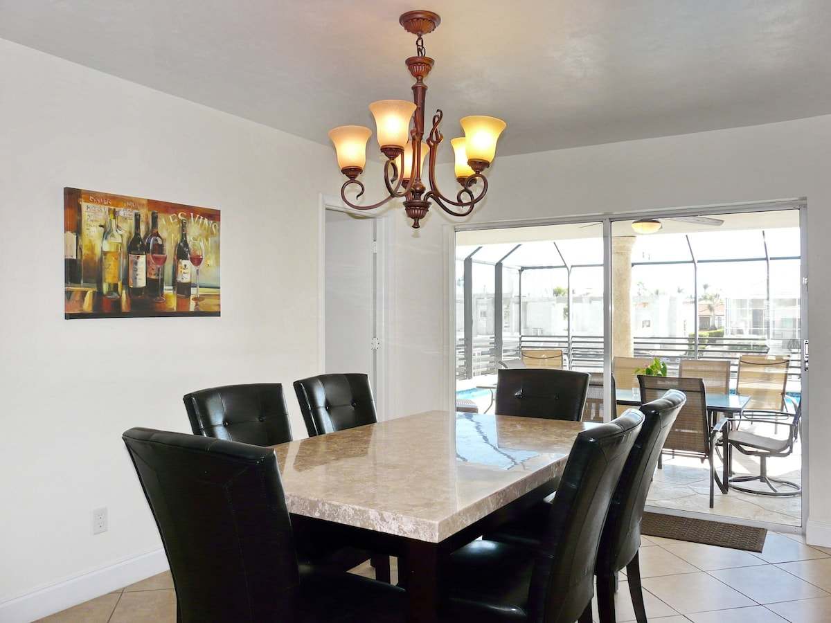 Dining table with six chairs, opening to the screened lanai