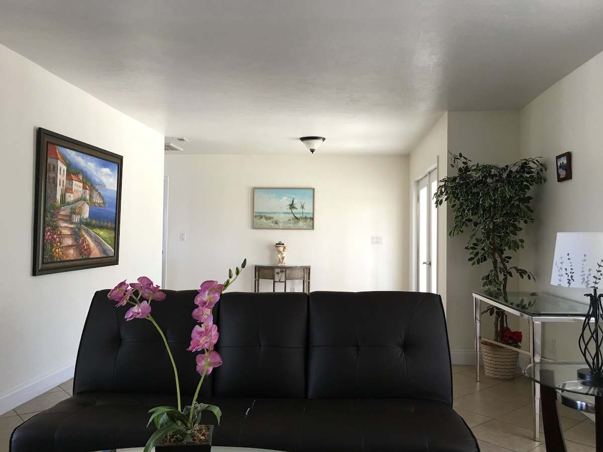 Living area with a black leather sofa