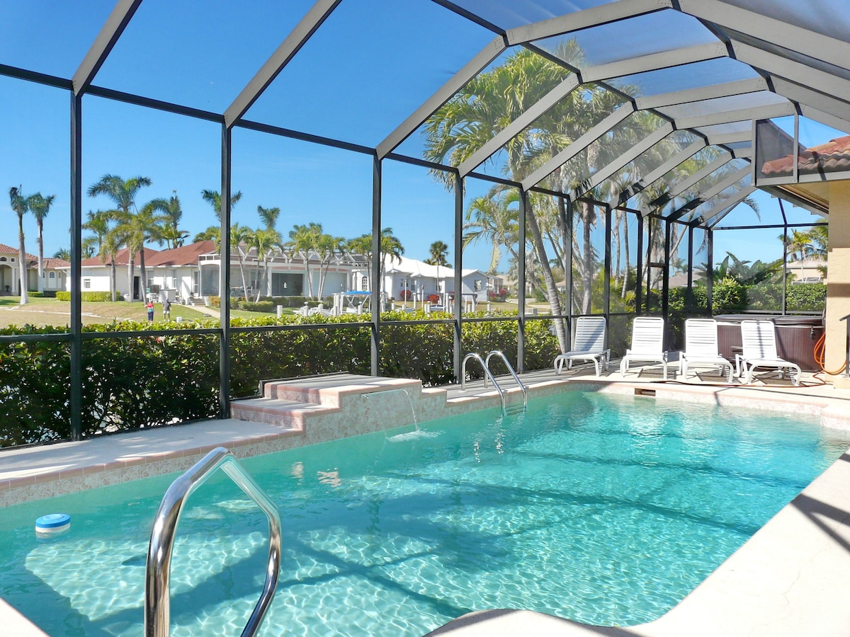 Screened heated pool with lounge chairs under a lanai